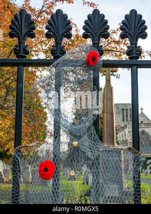 Haddington, East Lothian, Schottland, Vereinigtes Königreich, 6. November. UK Wetter: Sonnenschein bei St Marys" Pfarrkirche, wo ein handcrafted Soldat von Chicken Wire Mesh mit Mohn verziert wacht an der Pforte Stockfoto