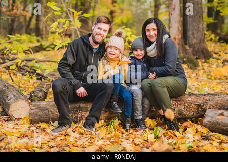 Eine glückliche Familie im schönen Herbst Park ruhenden Stockfoto