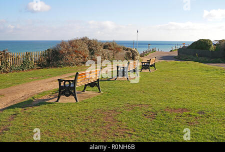 Eine Reihe von Sitzen an der Spitze der Klippen mit Blick auf das Meer mit Zugang zum Strand in North Norfolk an Overstrand, Norfolk, England, Vereinigtes Königreich, Europa. Stockfoto