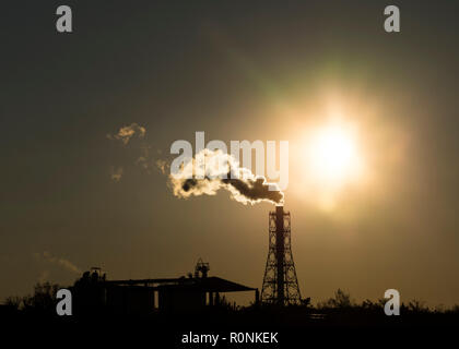 Factory Schornstein abgibt oder Entladungen schwere raucht bei Sonnenuntergang Erstellen von Umweltverschmutzung. Stockfoto