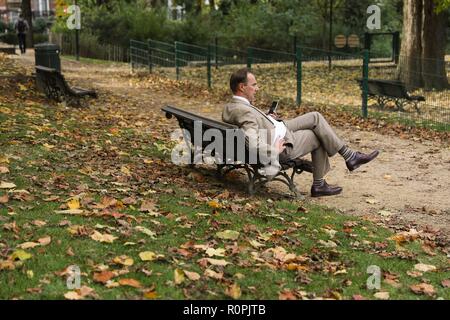 Brüssel, Belgien. 6 Nov, 2018. Ein Mann ruht in einem Park in Brüssel, Belgien, November 6, 2018. Die Menschen gingen im Freien Herbst Landschaft in Brüssel zu erleben. Credit: Zheng Huansong/Xinhua/Alamy leben Nachrichten Stockfoto