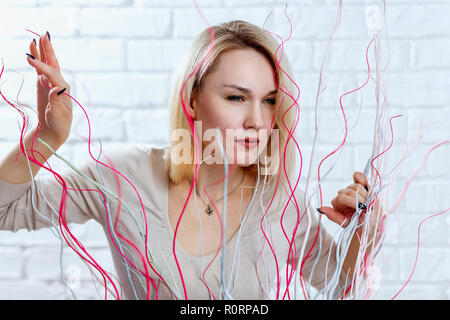 Frau mit argwöhnischen Augen Blick auf die Dekoration im Studio. Stockfoto