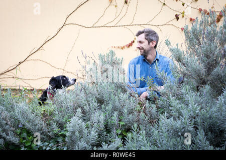 Porträt der Grafikdesigner Andreas Knapp, das mit seinem Hund Momo, ein Border Collie, in ein Stop in Lissabon, während Reisen durch Europa. Stockfoto