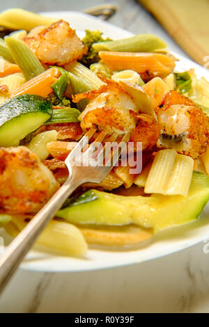 Garnelen Primavera mit Trikolore Penne in einer Weißweinsauce Stockfoto