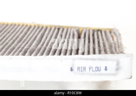 Changing a  car cabin pollen filter . High efficiety particle air filter.(Old one)  white background cutout Stockfoto