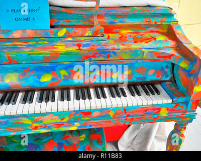 Ein lebendiges, handgemaltes „Kunstklavier“ mit mehrfarbigen abstrakten Mustern, das für interaktive Musik und Kreativität in den öffentlichen Raum konzipiert wurde. Stockfoto