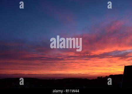 Sonnenuntergang auf Mumbles. Die untergehende Sonne verschwindet unter dem Horizont verursacht atmosphärische Refraktion erstellen die schöne Spektrum der Farben in den Himmel. Stockfoto