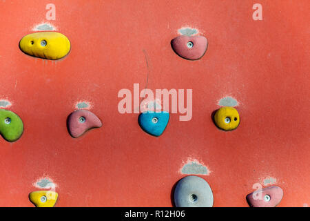 Klettern oder Bouldern Wand mit bunten Hand hält. Stockfoto