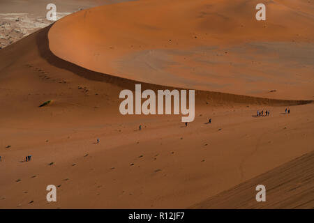 Touristen klettern auf Sanddünen, Sossusvlei, Namib-Wüste, Namib-Naukluft Park, Namibia Stockfoto