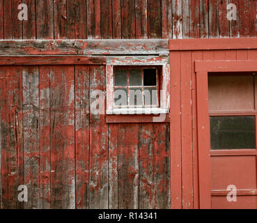 Verwitterte roter Farbe und zerbrochene Fenster sind eine gemeinsame Website auf Scheunen in Vermont. Stockfoto