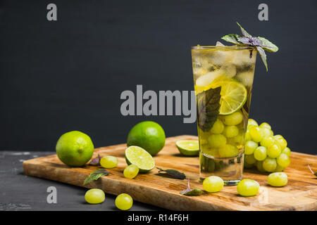 Frischen Cocktail mit Trauben-, Kalk- und Basilikum. Geringe Tiefenschärfe. Stockfoto