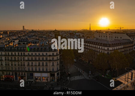 Gelb leuchtenden Sonnenuntergang auf Paris Dach der alten steinernen viktorianischen Gebäude mit den Eiffelturm noch nicht beleuchtet, Frankreich Stockfoto