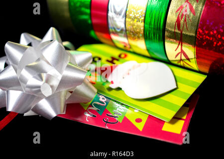 Weißes Satinband mit bunten Weihnachten Geschenkpapier Stockfoto