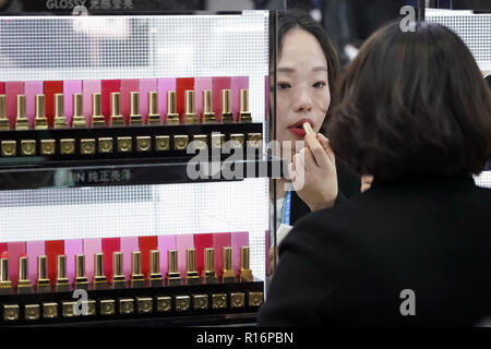 Shanghai, China. 9 Nov, 2018. Ein Besucher versucht, einen Lippenstift in der Bekleidungs-, Zubehör- und Konsumgüter bereich der ersten China International Import Expo (CIIE) in Shanghai, China, November 9, 2018. Credit: Shen Bohan/Xinhua/Alamy leben Nachrichten Stockfoto