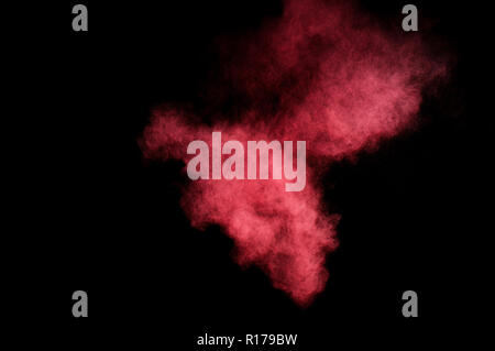 Rot und rosa Pulver Explosion auf schwarzen Hintergrund. Farbige Pulver cloud. Bunte Staub explodieren. Farbe Holi. Stockfoto