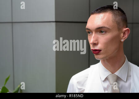 Junge androgyne homosexuellen LGTB Geschäftsmann Denken im Freien Stockfoto