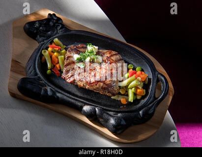 Tomahawk plating, Steak in Scheiben geschnitten gegrilltes Rindfleisch Grill Roastbeef und Salat mit Tomaten Stockfoto