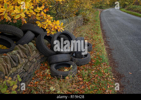 Ein Haufen von gebrauchten Autoreifen entleert auf Seite eines ziemlich country lane in Einsiedler Hill, Wortley, Sheffield, Großbritannien Stockfoto