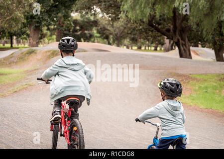 Zwei australische Kinder reiten ihre Fahrräder auf speziellen Radweg in Adelaide, South Australia Stockfoto