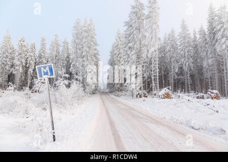 Treffpunkt auf einem schmalen Waldweg in einer schönen Winterlandschaft Stockfoto