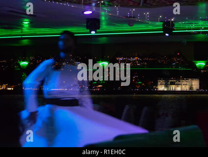 Unscharfe Reflektion im Glas wirbelnder Derwisch auf dem Hintergrund der Nacht Istanbul. Stockfoto