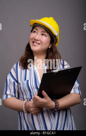 Reifen asiatischen Geschäftsfrau Bauarbeiter tragen, hardhat Stockfoto