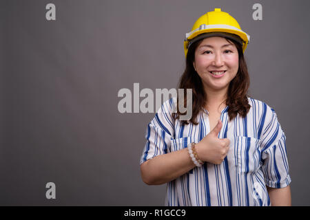 Reifen asiatischen Geschäftsfrau Bauarbeiter tragen, hardhat Stockfoto