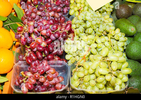 Basketsful mit frischen Ernte von Rose und weiß Tafeltrauben in einem obstmarkt. Ernährung und Gesundheitswesen Konzept. Stockfoto