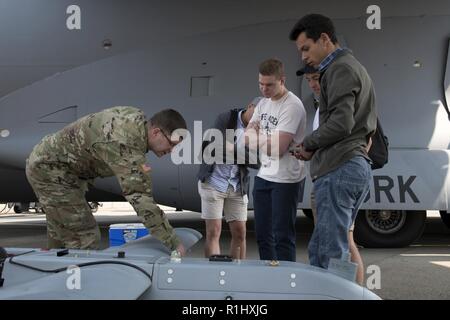 Spc. Alexander Pfeifer, ein unbemanntes System Operator, D. Co 152 Brigade Ingenieur Bataillon zugeordnet, erklärt die Funktionen der RQ-7 Shadow zu den Einheimischen in Waterkloof Air Force Base, Südafrika während der Afrikanische Luft-/Raumfahrt- und Verteidigungsindustrie Ausstellung, Sept. 20, 2018. Piper ist Teil eines Kontingentes von New York Luft und Armee Wachmännern Streitkräfte ihren Stand auf der Messe vertreten. Stockfoto