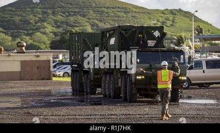 Ein US-Marines mit Combat Logistik Bataillon 3 (CLB-3) führt eine 7-Tonnen-LKW auf eine logistische Unterstützung Schiff (LSV) an der Marina auf der Marine Corps Base Hawaii, Kaneohe Bay, Okt. 7, 2018 zu laden. Das Zahnrad und die Geräte geladen wird, wird auch auf der grossen Insel von Hawaii für Übung Bougainville II. transportiert werden. Stockfoto