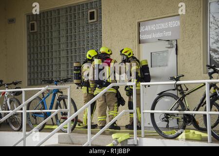 Us-Armee die zivilen Feuerwehrmänner von U.S. Army Garrison (USAG) Ansbach Evakuierung und Rettung Verfahren auf Bataillon und Feuerwehr Hauptquartier bei Storck Baracken in Illesheim, Deutschland, Okt. 10, 2018 demonstrieren. Die Demonstration ist Teil der jährlichen Einhaltung der Garnison von Brandschutz Woche. Stockfoto