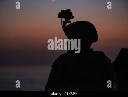 Straße von Hormuz (Okt. 2010) 10, 2018) US Marine Corps Lance Cpl. Mitchell Spears, zu Bataillon Landung Team 3/1 zugeordnet, steht kleinen craft Assault team Watch an Bord Wasp-Klasse amphibisches Schiff USS Essex (LL 2), während der Durchfahrt der Straße von Hormuz während einer planmäßigen Einsatz von Essex Amphibious Ready Gruppe und 13 Marine Expeditionary Unit. USS Essex ist eine tödliche, flexibel, und anhaltende Navy-Marine Corps Team in die USA 5 Flotte Bereich der Maßnahme zur Unterstützung der Marine im Einsatz für die Stabilität und Sicherheit in der Region zu gewährleisten, Anschließen der Medite Stockfoto