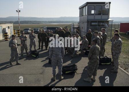 Us Air Force Staff Sgt. Robert Welborn (links), 435Th Konstruktion und Training Squadron Feuerwehr und Kontingenz Ausbildung Instructor, debriefings Lettische und litauische Luftwaffen Feuerwehrmänner nach einem Tag der Bereich Ausbildung während der US-Streitkräfte in Europa NATO Feuerwehrmann Partnerschaft Kurs auf der Air Base Ramstein, Deutschland, Okt. 10, 2018. Etwa 20 Lettische und litauische Luftwaffen Feuerwehrmänner in dem 5-tägigen Kurs, nahm auf vertraut zu NATO-Verbündeten mit Crash und Brand Verfahren, sodass Partner Nationen zusammen in jeder Situation zu arbeiten. Stockfoto