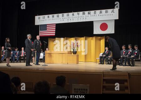 Rie Miyoshi, Stars und Stripes Tokio Management Analyst, Bögen als Zeichen des Respekts, nachdem Sie eine Auszeichnung für Ihre Jahre Dienst an der USFJ Länge-von-Service Preisverleihung im Rathaus in Hamura Yutorogi Stadt, Japan, Okt. 10, 2018. Die Veranstaltung bot die Gelegenheit, sowohl für die Usfj und der Regierung von Japan den Dienst der lokalen nationalen Mitarbeiter, die 10, 20, 30 und 40 Jahren für den Erfolg und das Wachstum der Partnerschaft zwischen den USA und Japan beigetragen haben zu feiern. Stockfoto