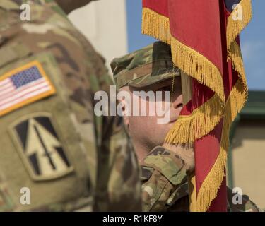 Command Sgt. Maj. Steven Bischof, abgehenden älteren eingetragenen Berater für die 76th Infantry Brigade, 38th Infantry Division, Indiana Army National Guard, bereitet die Brigade Farben zu Oberst Robert Burke, abgehende Brigadegeneral bei einem Befehl Zeremonie, die einen neuen Kommandanten und Senior noncommissioned Officer, installiert Samstag, Oktober 13, 2018, in Lawrence, Indiana. Stockfoto