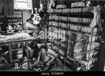 80/27 Kind Arbeiter in der Fabrik, die Sauger für Babyflaschen, Old Dhaka 1980 Stockfoto