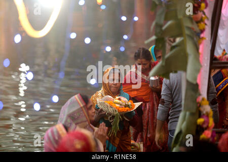 Eine Nepalesische devotee gesehen Gebete an die untergehende Sonne auf dem Wasser während der CHHATH Puja Festival. Die Chhath Festival, auch als Surya Pooja, oder Anbetung der Sonne bekannt, ist in den Teilen von Indien und Nepal als Anhänger beobachtet Hommage an die Sonne und das Wasser Götter zahlen. Stockfoto