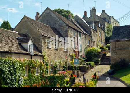 Tetbury, Gloucestershire, Großbritannien - 23 August 2017: Eine ikonische Cotswold Stadt Idylle Foto ist verdorben durch einen aufdringlichen Immobilienmakler Schild und Freileitungen. Stockfoto