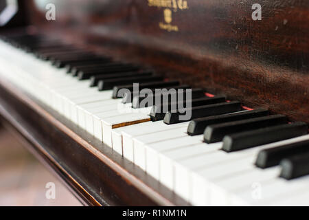 Einer Ansicht einer Oldtimer Grand Piano Keyboard, mit Jahren der Verschleiß, auf einer Taste klemmt zentriert. Stockfoto