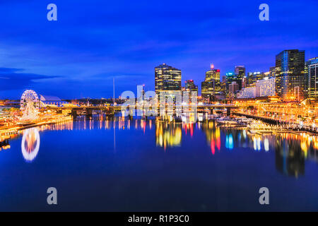 Blau dunkel Sonnenuntergang in Darling Harbour Vergnügungsviertel von Sydney CBD, wenn helle Beleuchtung leuchten in stille Wasser der Cockle Bay. Stockfoto