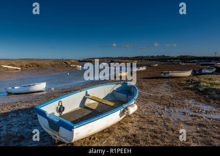 Morston Kai und Creek in atmosphärischen North Norfolk. Kleine Boote auf alte hölzerne Stege und Pontons auf einem hellen herbstlichen Tag günstig Stockfoto