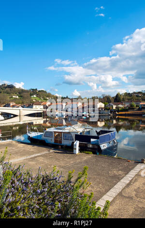 Am 28. März 2017 - SAINT-SYLVESTRE-sur-Lot, Frankreich: Boote im Frühjahr morgen Sonnenschein vertäut auf dem ruhigen Fluss Lot bei Saint-Sylvestre-sur-Lot, Lot-et-Garonne, Frankreich. Auf der anderen Seite des Flusses ist Port de Penne, dem alten Flusshafen für Penne d'Agenais Stadt. Stockfoto