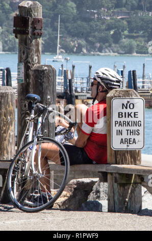 Männliche Radfahrer durch die Uferpromenade am Sausalito Ausruhen nach Radfahren aus San Francisco. Stockfoto