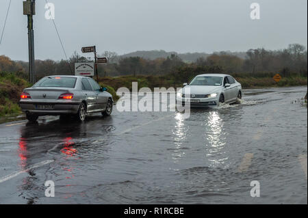 Dunmanway, West Cork, Irland. 14 Nov, 2018. Zwei Autos schlecht verhandelt eine überflutete Straße gerade außerhalb Dunmanway nach einer Nacht von sintflutartigen Regenfällen. Der Tag wird sehr nass und windig mit Höhen von 13 bis 15°C. Credit: Andy Gibson/Alamy Leben Nachrichten. Stockfoto