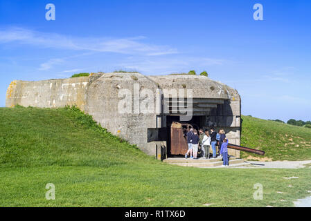 Touristen mit Führung Besuch Bunker der Batterie Le Chaos, Teil der Atlantikwall bei Longues-sur-Mer, Normandie, Frankreich Stockfoto