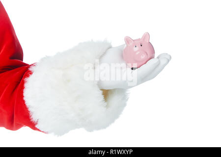 7/8-Ansicht von santa claus Holding kleines Sparschwein in der Hand isoliert auf weißem Stockfoto