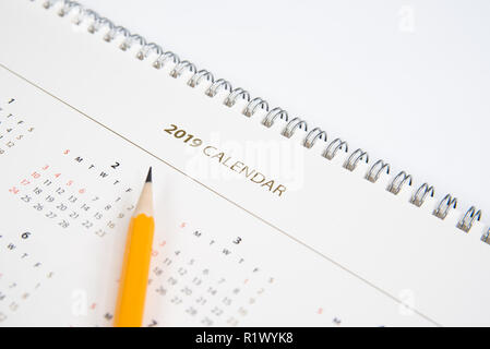 Schreibtisch Kalender und gelben Bleistift auf weißem Hintergrund. Stockfoto