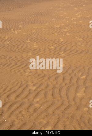 Druckt in den Sand am Strand Stockfoto