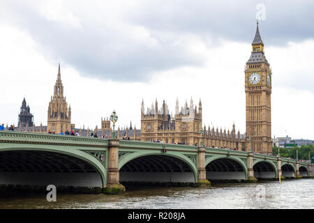 London/England - 06.03.2014: London Westminster Bridge mit Häusern des Parlaments im Hintergrund auf Sommer Tag mit grauen Wolken Stockfoto