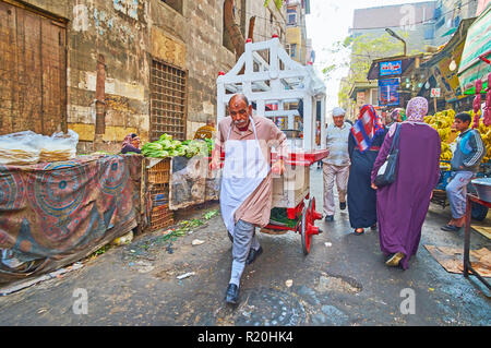 Kairo, Ägypten - Dezember 21, 2017: der Straße essen Verkäufer Spaziergänge entlang Al Khayama Straße mit seinem Essen Warenkorb, am 21. Dezember in Kairo. Stockfoto